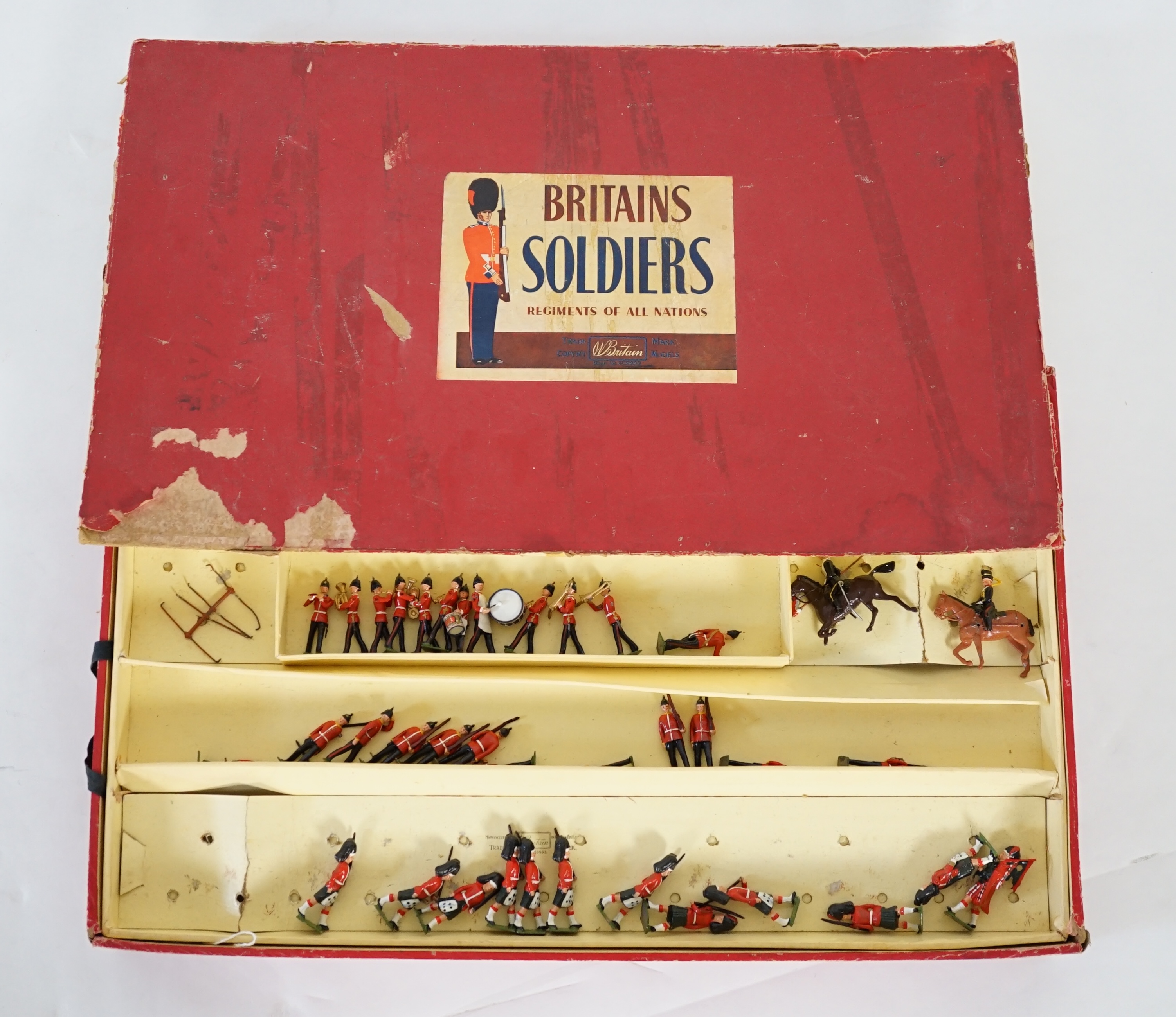 A Britains ‘Regiments Of All Nations’ series box of lead soldiers, including twelve Scottish Highlander infantrymen, eleven marching bandsmen